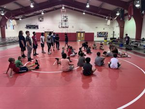 Young wrestlers on a mat in a gym