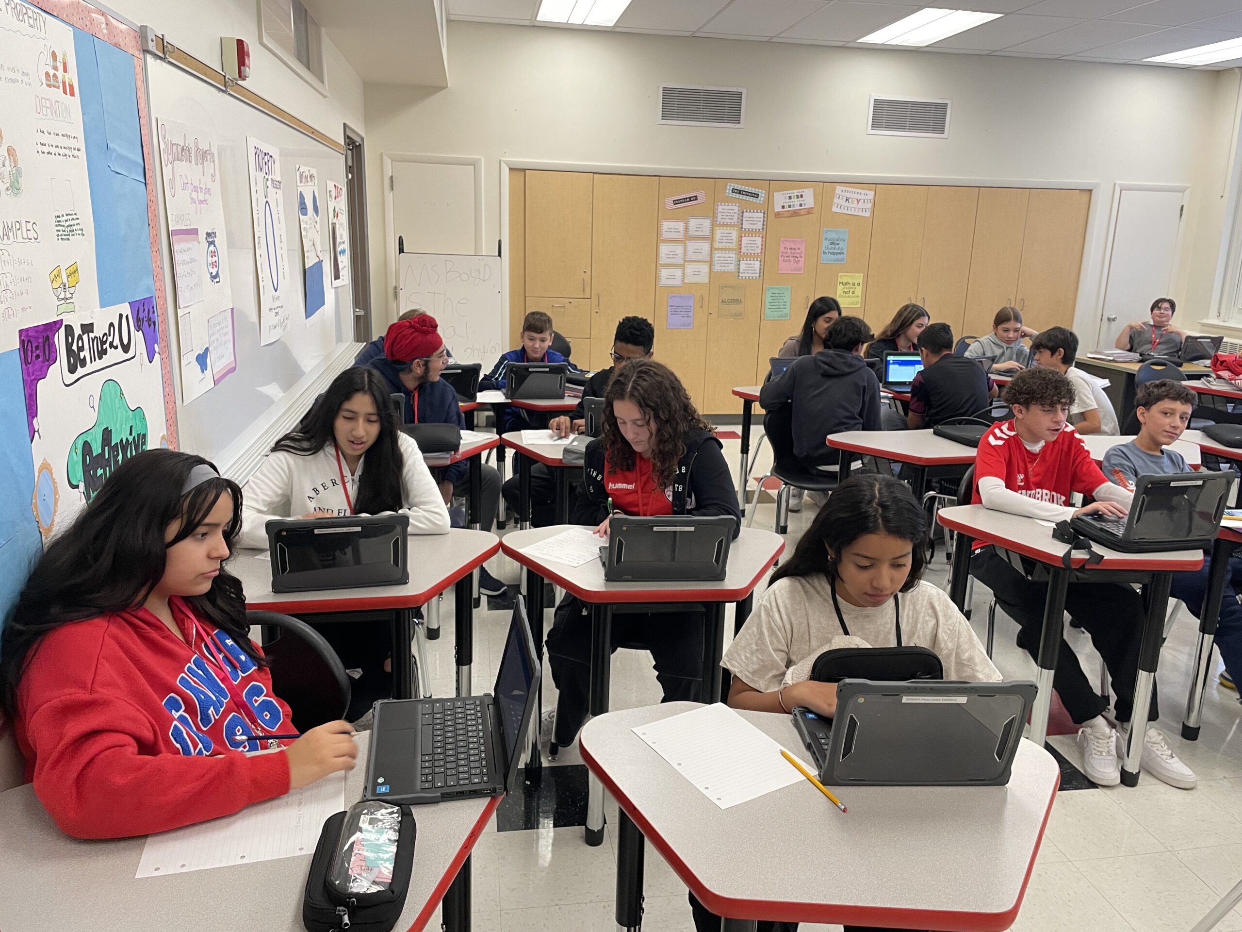 Students work at their desks using the new Chromebooks during math class at Community Middle School..